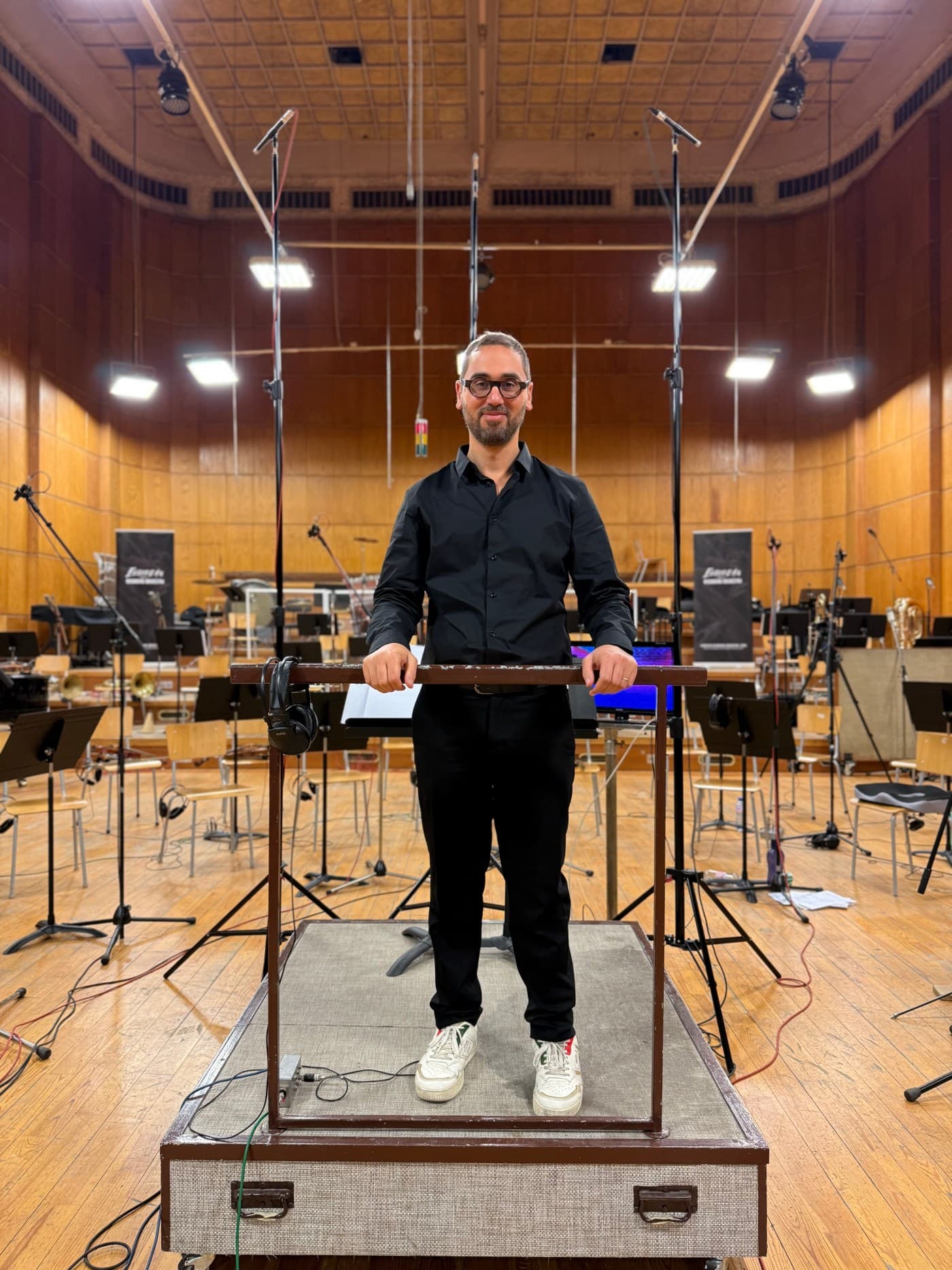Marco Di Stefano on the podium in a recording hall